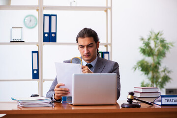 Young male lawyer sitting in the office