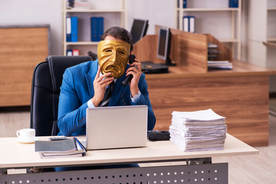 Young Male Employee Wearing Sad Mask In The Office