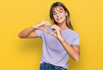 Teenager caucasian girl wearing casual clothes smiling in love doing heart symbol shape with hands. romantic concept.