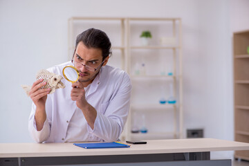 Young male zoologist student studying fish skeleton