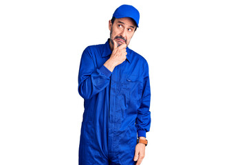 Middle age handsome man wearing mechanic uniform thinking worried about a question, concerned and nervous with hand on chin