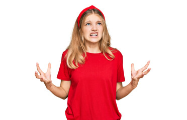 Beautiful young caucasian girl wearing casual red t shirt crazy and mad shouting and yelling with aggressive expression and arms raised. frustration concept.