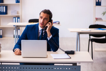 Young male employee working in the office