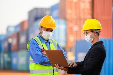 Engineer or Foreman Talk to an Asian businessperson about loading containers from a cargo ship.