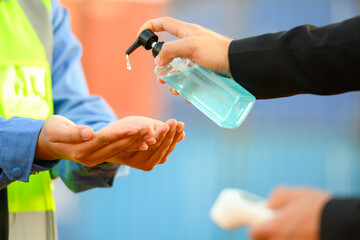 Hand washing with alcohol hand sanitizer and measuring temperature with an employee thermometer before entering work. Prevent coronavirus infection (COVID-19)