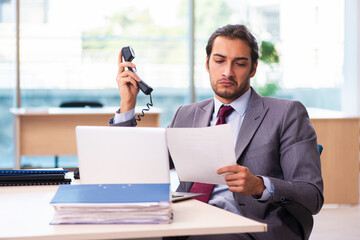 Young male employee working in the office