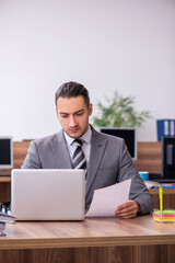 Young male employee working in the office