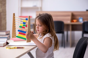 Small girl preparing for exams at home