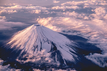 Panoramic plane view of beautiful sunset in the sky over clouds and Mount Fuji, Japan