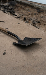 breaking up an asphalt driveway with shovel