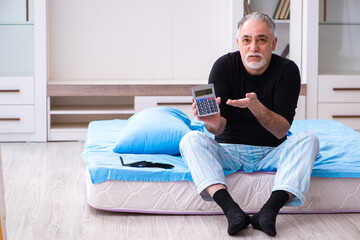 Old man in bankruptcy concept in the bedroom