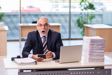 Aged businessman employee unhappy with excessive work