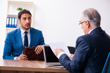 Fototapeta premium Young male candidate employee meeting with old recruiter