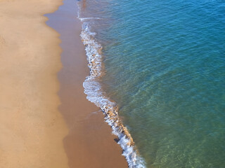 Aerial view of red sandy beach and blue sea