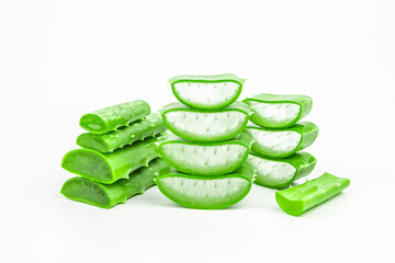 Pile of fresh aloe vera plant slices stacked and aloe vera stalk or leaves with water dropping isolate on white background.