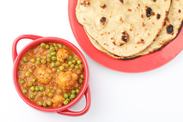 gobi mutter or cauliflower and green peas gravy with tandoori roti and cucumber, North Indian food