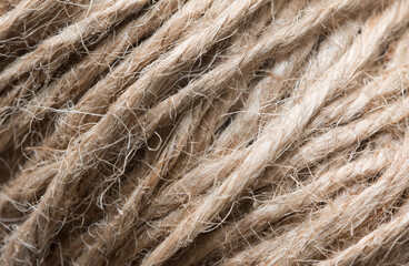 Close up background texture of brown twine wound on a reel. Natural hemp fibers used in production. 