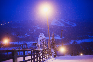 Beautiful night cold scandinavian mountain view of ski resort, sunny winter day with slope, piste...