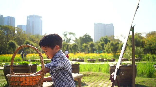 Little boy drawing imgae of flower in city park outdoor activity