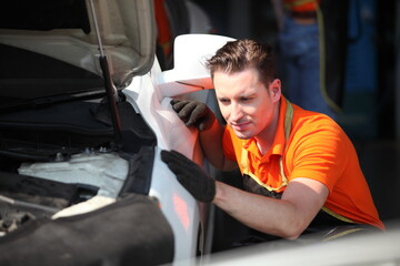 Portrait of a mechanic at work in his garage or car repair service or auto store, business, maintenance and people concept