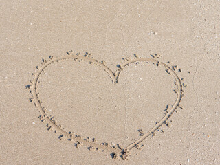 heart symbol written on sand as a background. Valentines day concept.