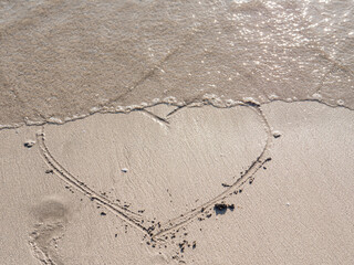 heart symbol written on sand as a background. Valentines day concept.