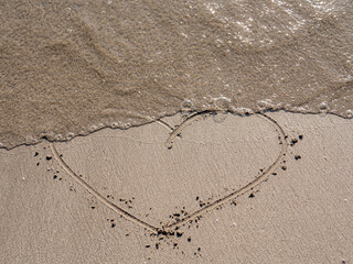 heart symbol written on sand as a background. Valentines day concept.