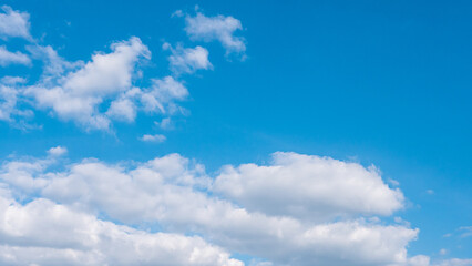 White clouds cumulus floating on blue sky for backgrounds concept.