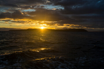 Fototapeta na wymiar Sunset above the ocean horizon