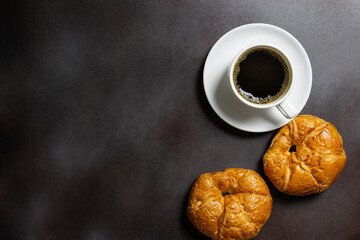 Breakfast / black coffee and croissants on the table /  flat top view with copy space for your text.