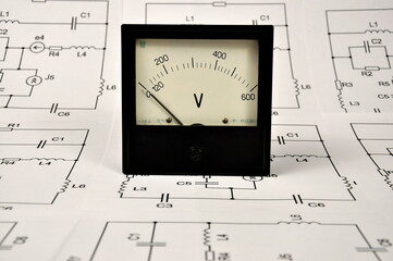 Black voltmeter and a wiring paper diagram.