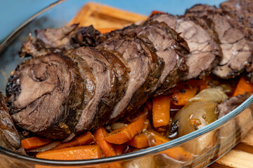 Wild boar - wild game meat. Oven baked wild boar fillet with vegetables close-up. Shallow depth of field.