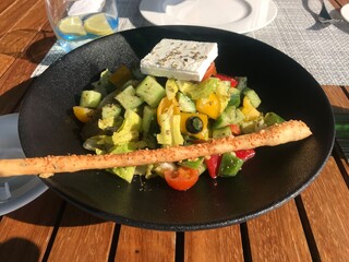 Greek salad served at an outdoor restaurant terrace