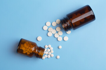 Various medicine. White round pills and two pill bottle