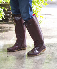 man in brown rubber boots on wet floor