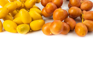Bunch of yellow raw Date Fruit or Medjool Dates (Phoenix dactylifera) from the palm tree isolated on White Background.Healthy lifestyle and Vegetarian concept