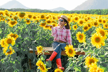Portrait of female farmer in sunflower field evening time at khao Yai thailand