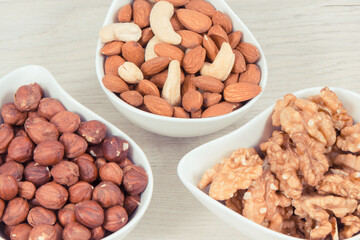 Various nuts and almonds in bowls, healthy nutrition and lifestyle concept