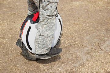 Man legs mono wheel personal electrical eco friendly transport rural scene outdoor © Roman