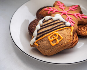 Gingerbread cookies with colorful glaze on a white plate