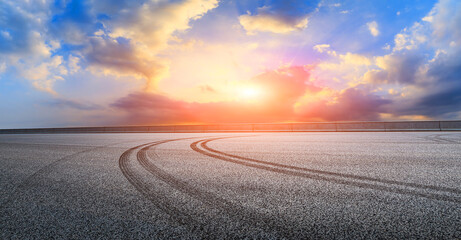 Asphalt race track road and sky clouds at sunset.Road ground background.