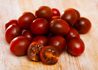 Fresh cherry tomatoes on wooden table, ingredients for cooking