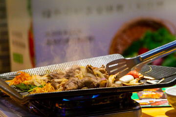 Indoor Asian grill on Flat Grill Plate close up. Chinese food.