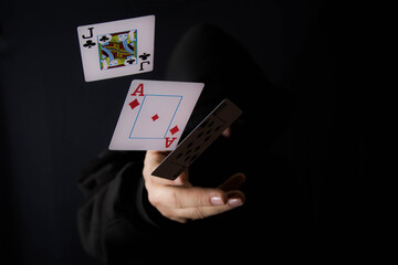 man with playing cards in the darkness