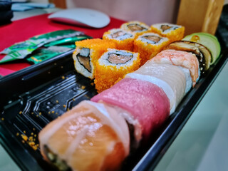 Close-up Sushi Set for Lunch on the Office Desk with Selective Focus