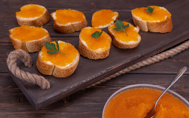 sandwiches with red caviar. selective focus. valuable food product, has high taste qualities and high cost, belongs to delicacies.