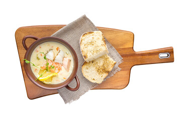A bowl of creamy soup with salmon. Restaurant service concept. Isolated.