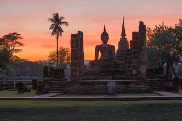 Ruins of the ancient Buddhist temple Wat Chana Songkhram against the backdrop of a bright sunset....