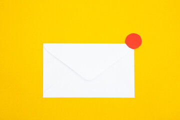Colorful paper envelopes on yellow background