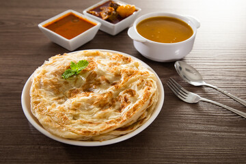 Roti Parata or Roti canai with lamb curry sauce.